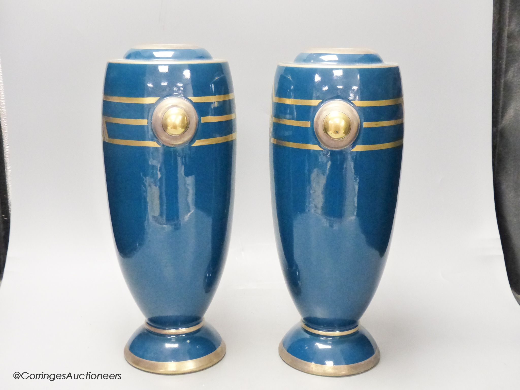 A pair of Art Deco blue glazed pottery vases, initialled PH, height 36cm